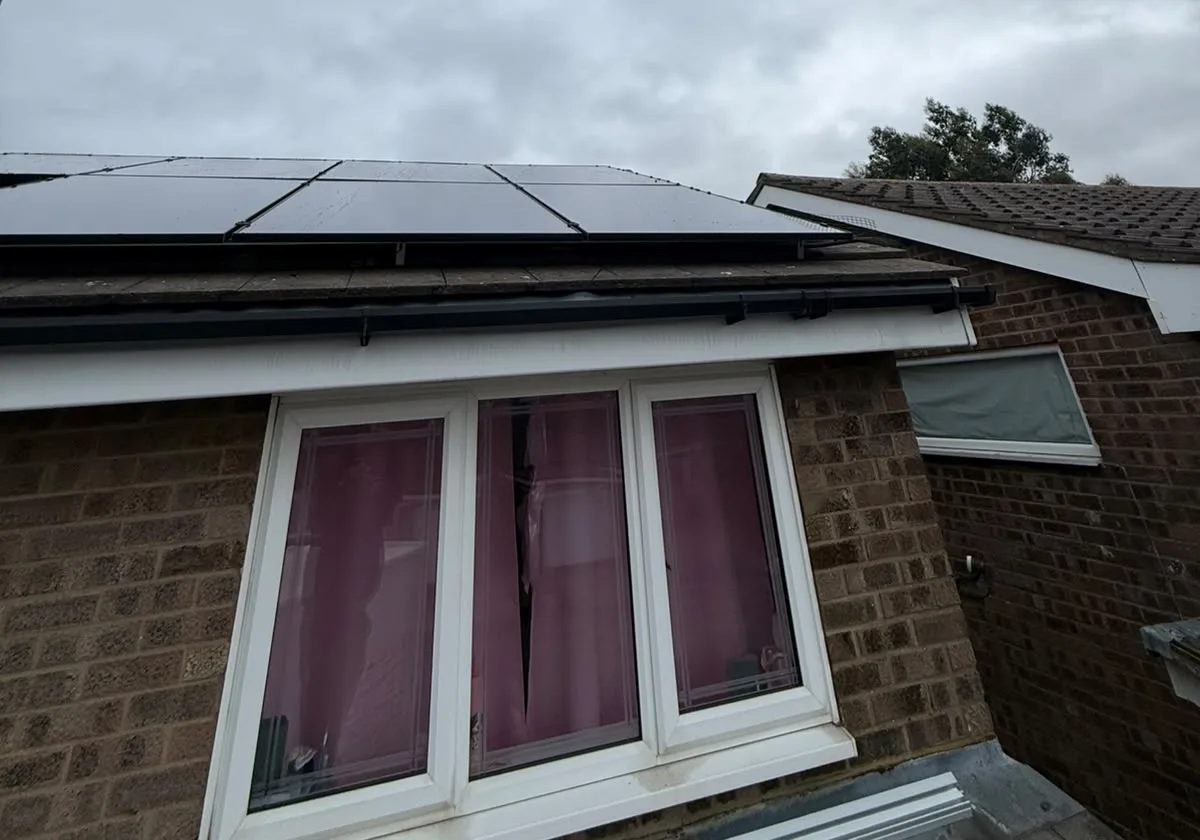 Close view of all-black DMEGC solar panels on a Bedford roof