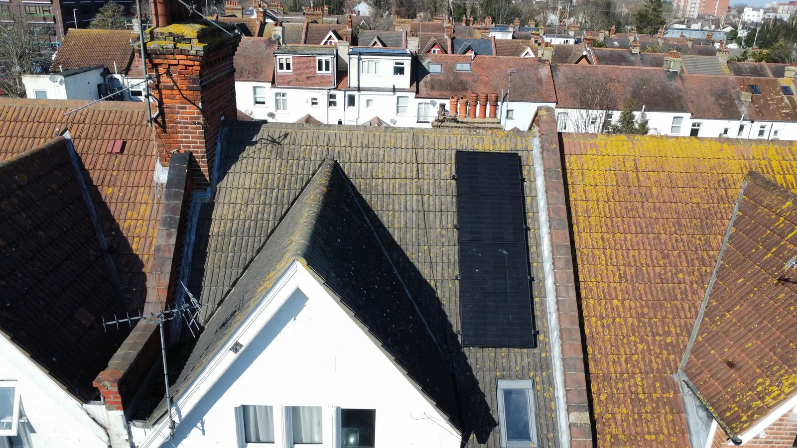 All-black solar panels on the rear roof face of a Southend-on-Sea terraced home, worked around the chimney