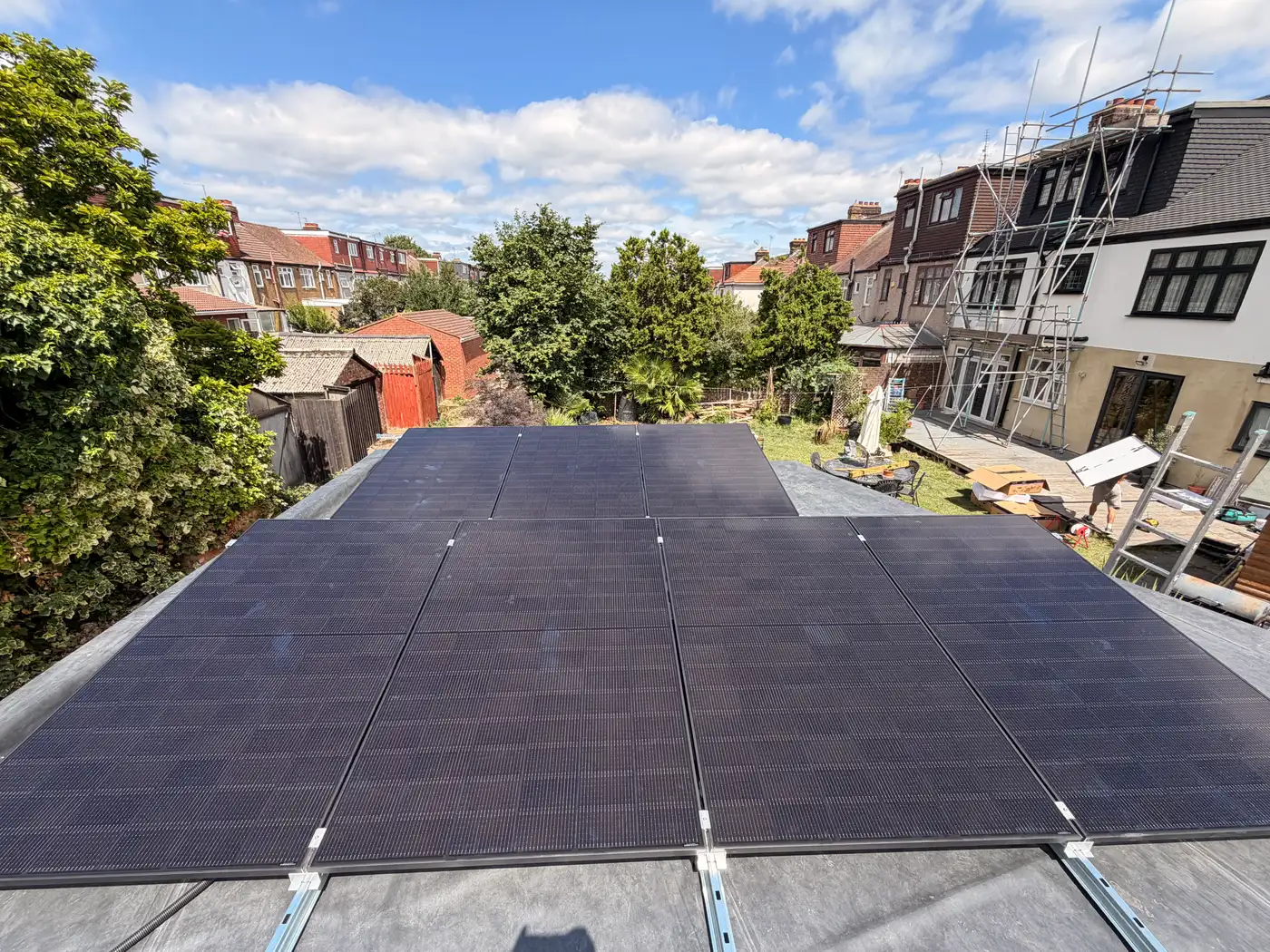 All-black solar panels on a flat extension roof in Romford, installed by ECONEXIS