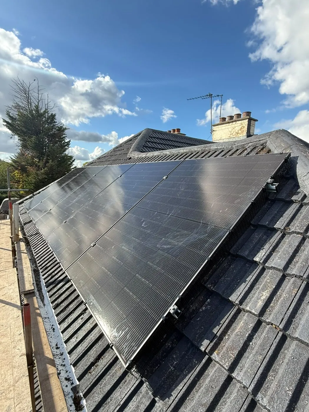 Twelve all-black DMEGC solar panels on a hip roof in Romford, installed by ECONEXIS