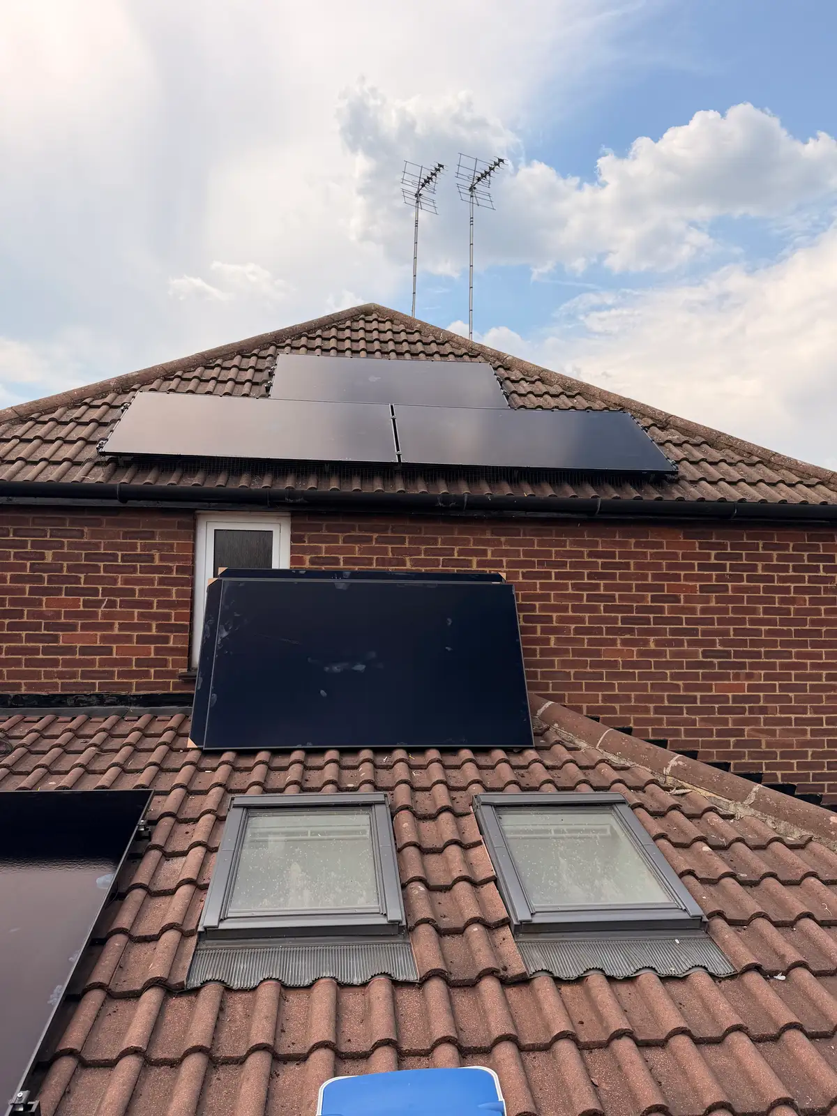 All-black solar panels around a hipped roof in Leighton Buzzard